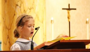 St. Theresa student reads at school Mass
